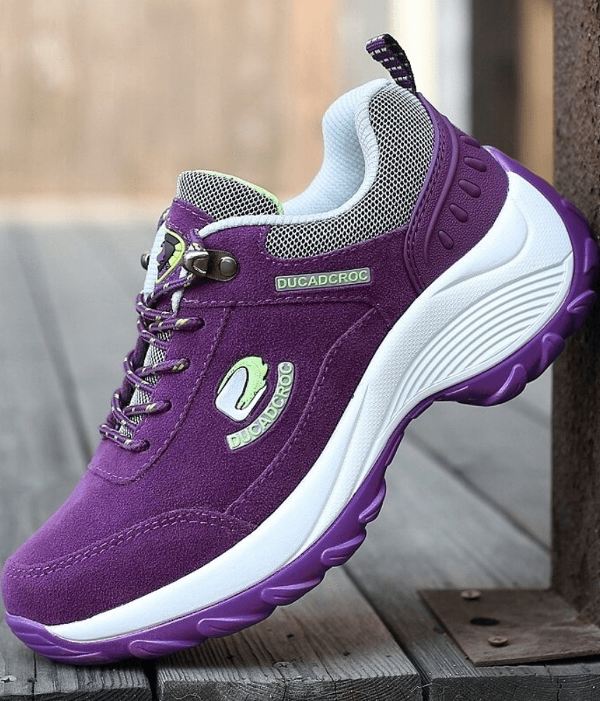 Vibrant purple women's sports sneakers with suede uppers and animal print. Lace-up design with white soles. Ideal for active style.